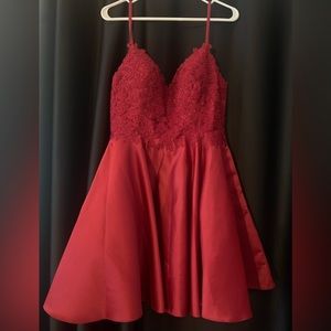 Short Red dress with flower detail on top and satin bottom. Size lg. 8-10